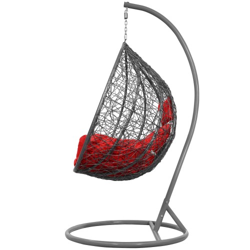 Charakteryzuje się nowoczesną stylistyką i kształtem kokonu, który zapewnia wygodne, otulające miejsce do relaksu. Kosz jest szary, a poduszki są w kolorze czerwonym.